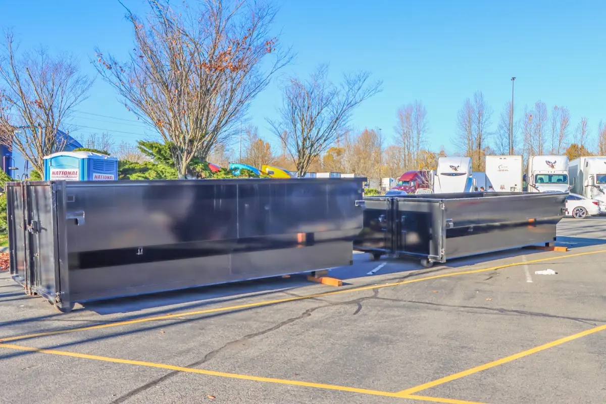 Professional dumpster rental service with roll-off container on residential driveway in Stonington